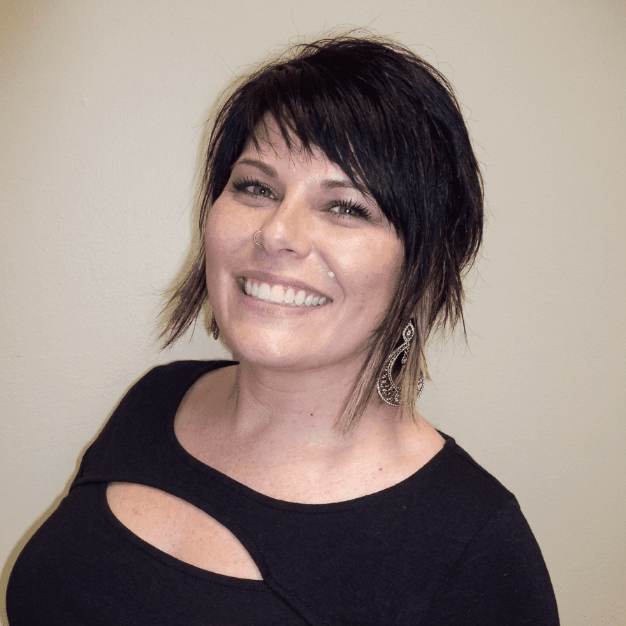 Portrait of Wendy, a professional stylist at Hair Sculptors Salon & Spa, showcasing their expertise and style.