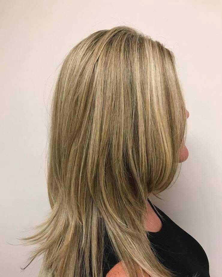 Short blonde layered haircut, side profile view.