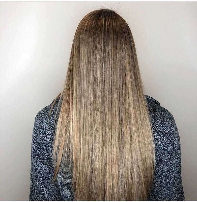 Long straight hair with a smooth, silky texture, against a neutral background.