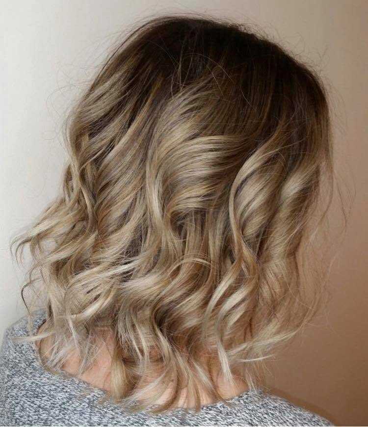 Wavy blonde hair styled in a bob cut.
